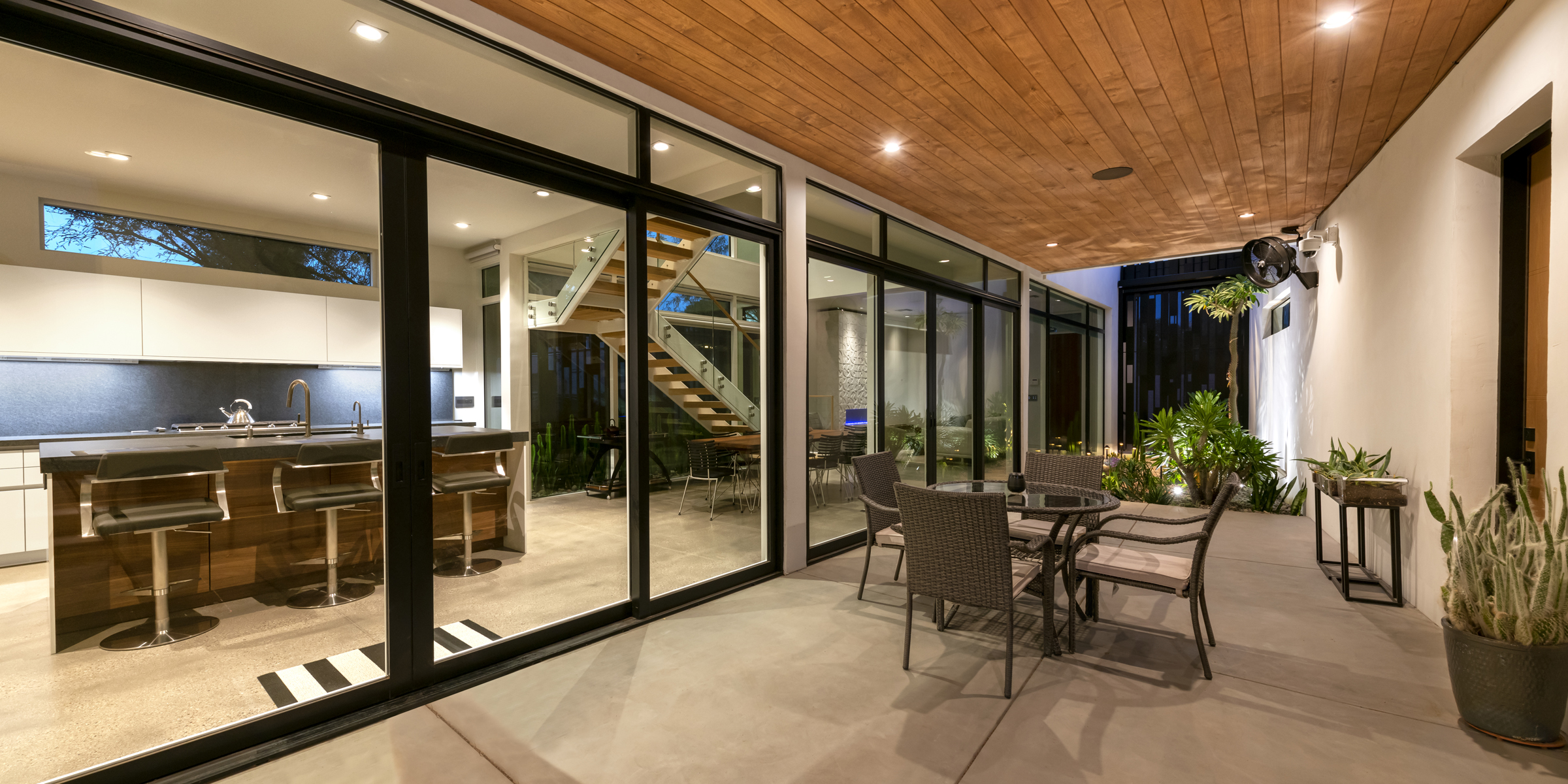 A RAS Architecture courtyard home opening to a shaded outdoor room